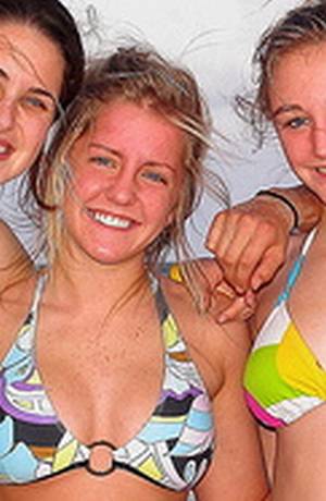 Vemos tres mujeres con bikini que sonríen a la cámara