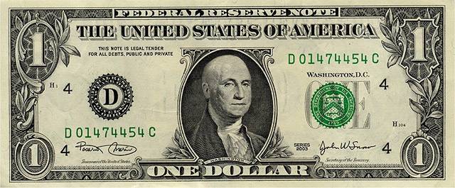 Vemos un billete de un dolar  donde la figura presidencial aparece sin pelo todo lo demás esta igual a hoy 