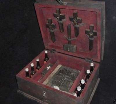 Vemos una  vieja caja donde hay varios crucifijos y tambien varios frascos 