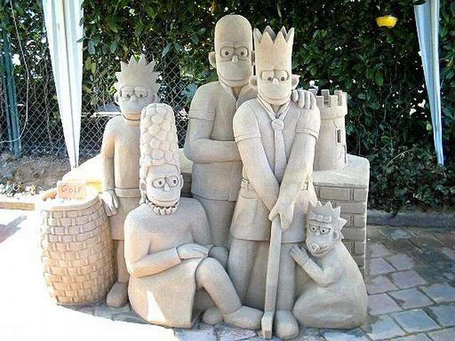 Vemos una pequeña familia de cuatro personas que posan tambien hechos en arena