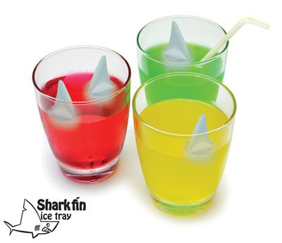 Tenemos tres vasos con bebidas de distintos colores y los cubos de hielo son figuras de tiburones