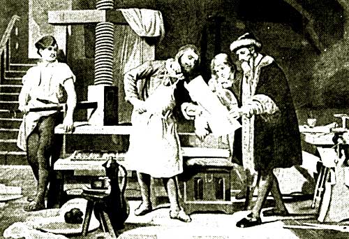 Cuatro personas en un taller mirando una hoja de papel grande