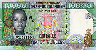 Vemos un billete en color verde y dorado y con una piña con la imagen de un joven y el billete con denominación de $10.000 guineas  