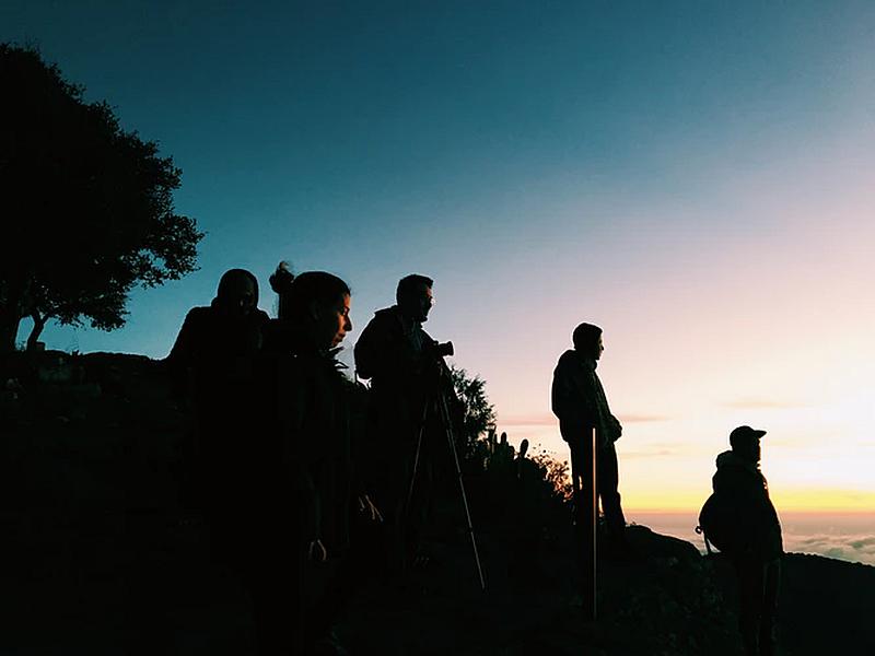 Vemos a varias personas con cámaras y trípodes en un atardecer